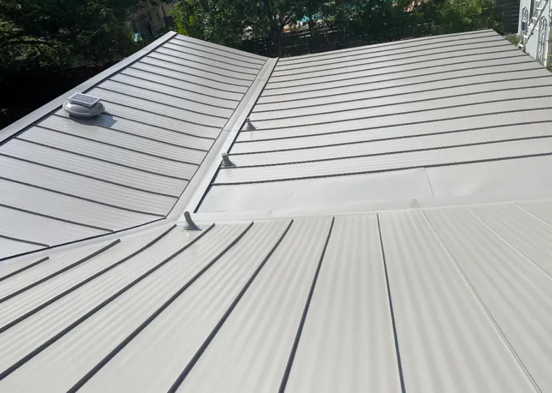 Solar attic fan installed on a metal roof for Roof Ventilation in Johns Creek
